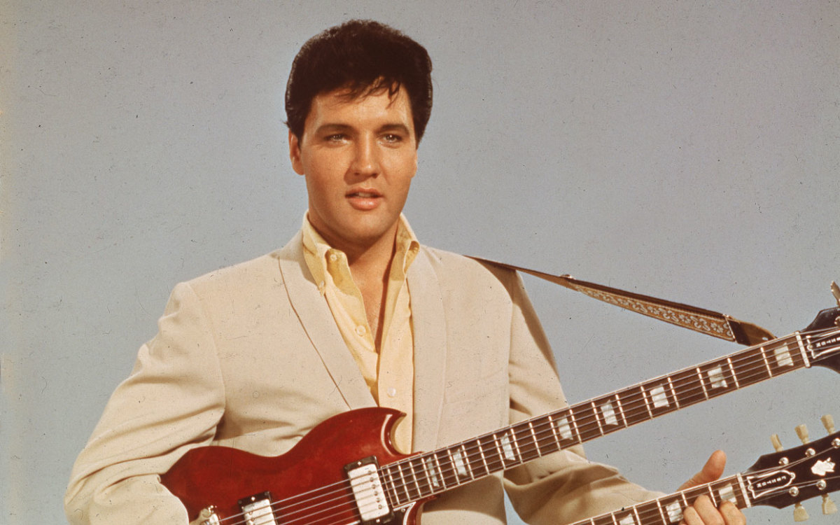 Which hip-swiveling icon claimed the 'King of Rock ‘n’ Roll' throne in the mid-50s?
