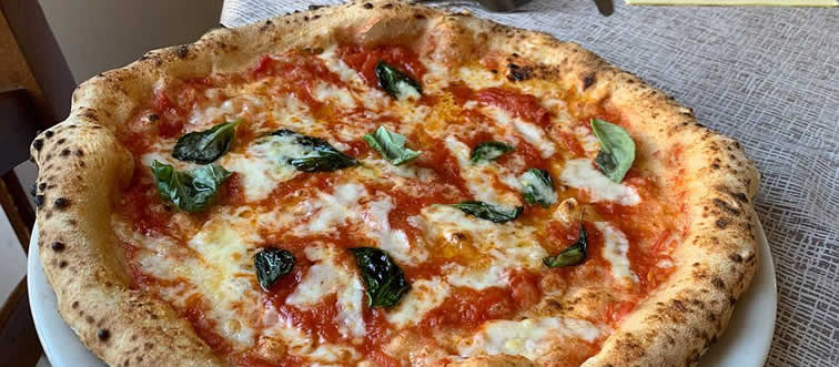 Which nation claims the throne as the birthplace of pizza?